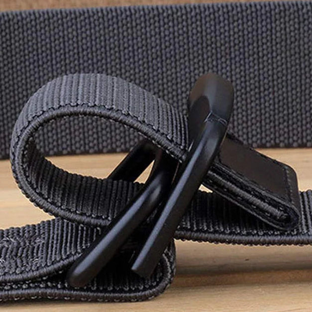 Gray strap with a black clip on a wooden surface