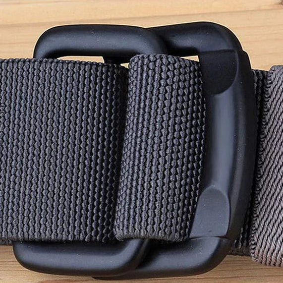 Gray belt with matte alloy buckle on a wooden surface