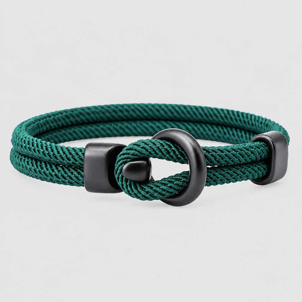 Teal braided bracelet with a gray metal clasp on a white background