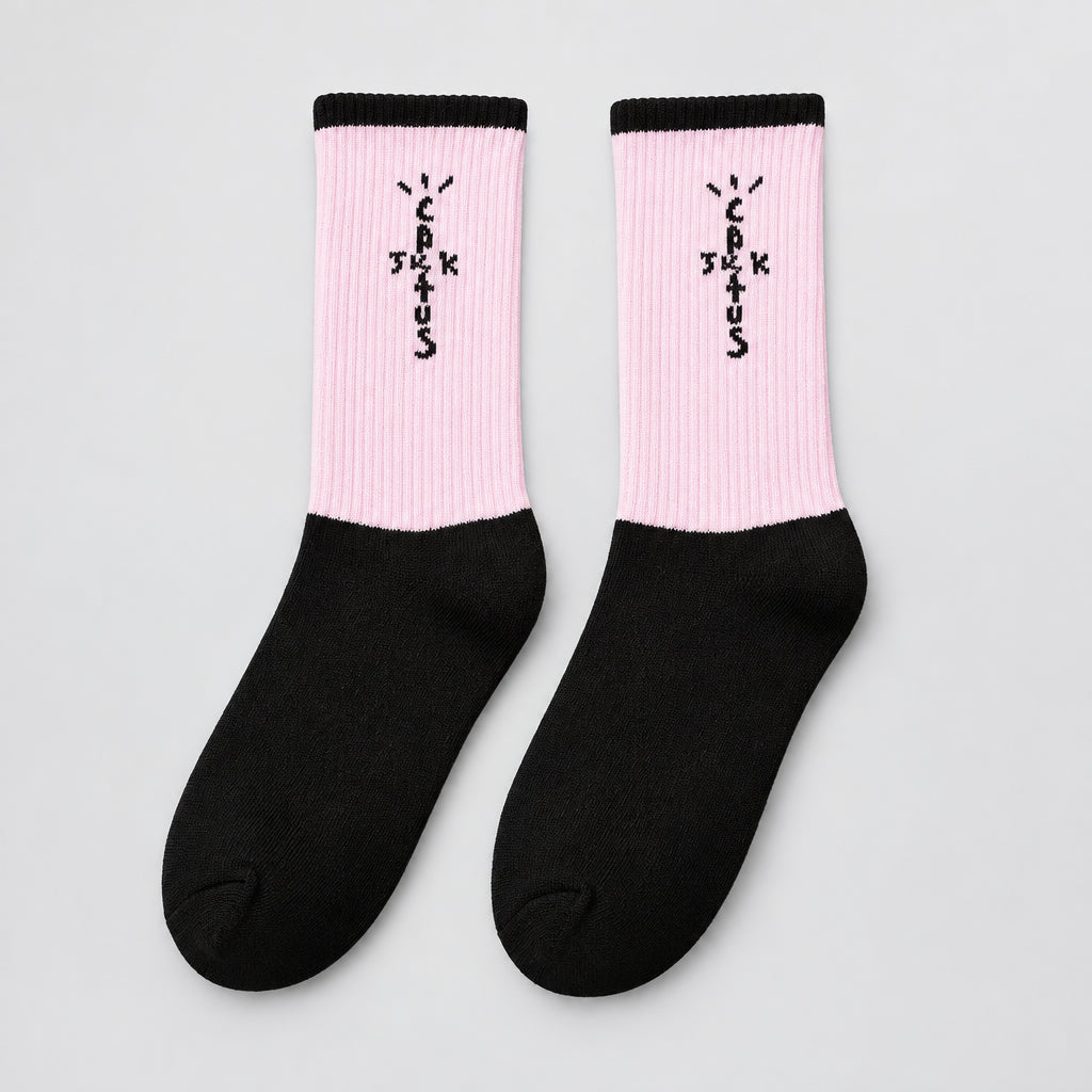 Pink and black crew socks with black cuffs and cross-shaped lettering, angled view