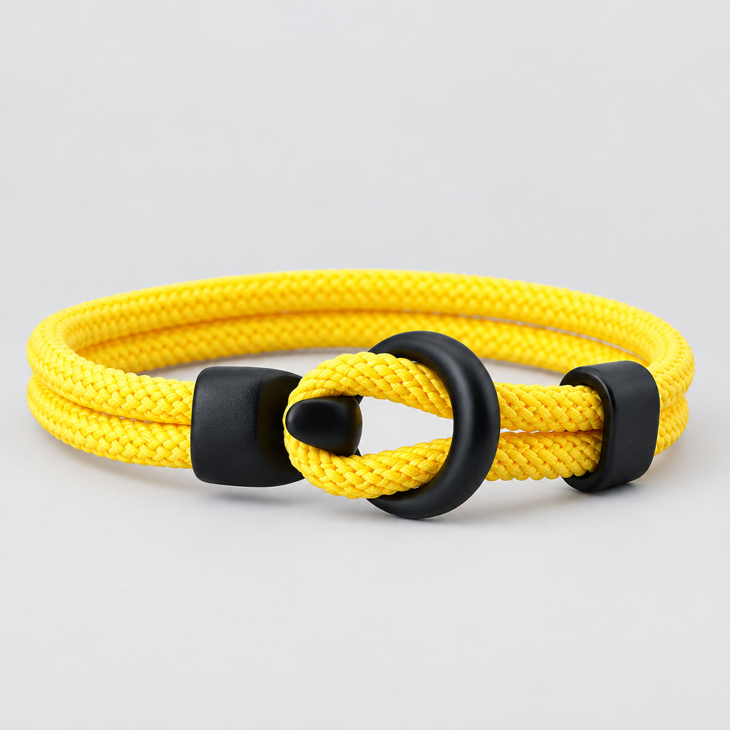 Yellow bracelet with black clasp on a white background