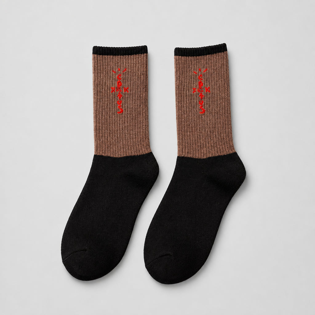 Brown and black crew socks with red cross-shaped lettering and black cuffs, angled view