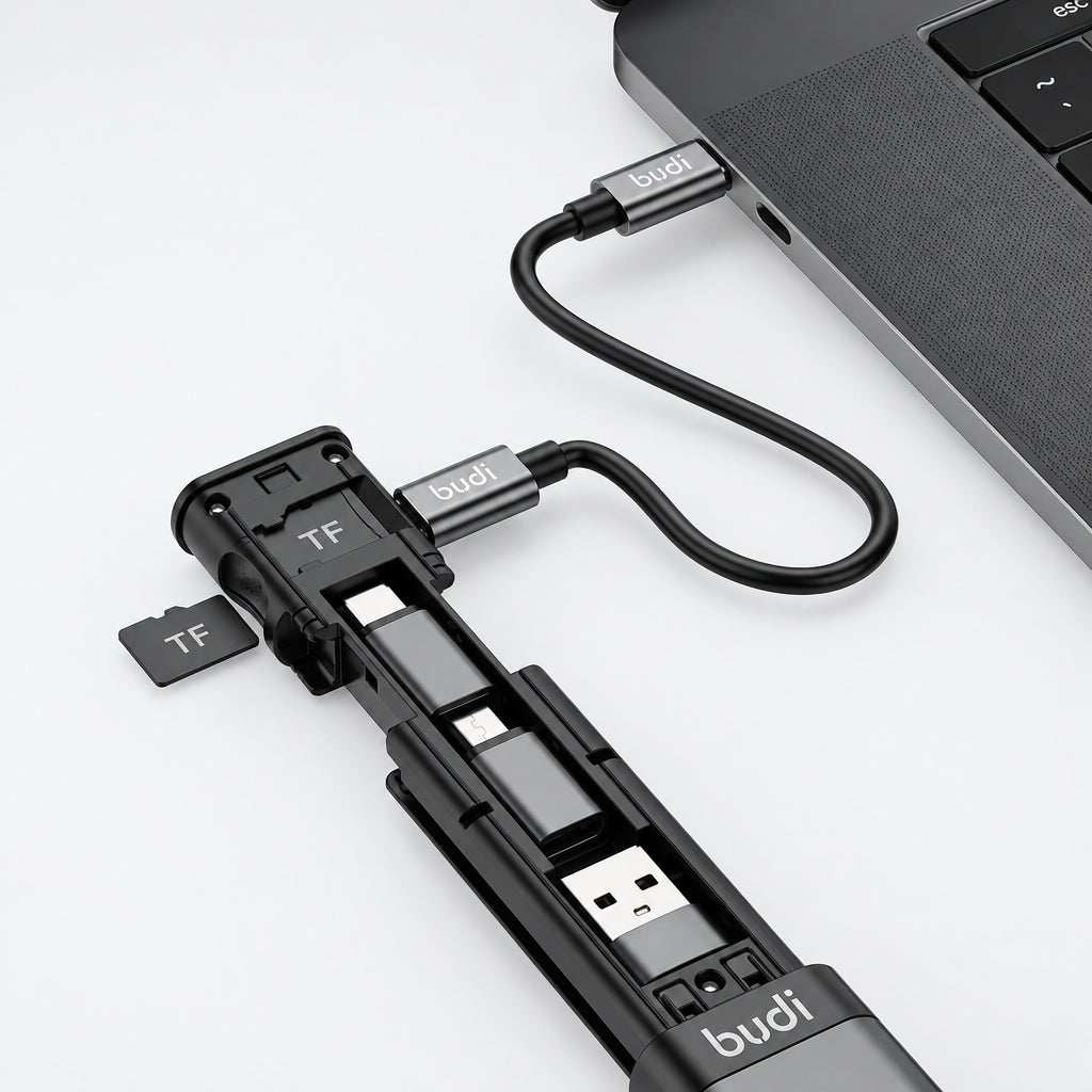 Multi-device charging cable with USB ports and TF card slot attached to a laptop.
