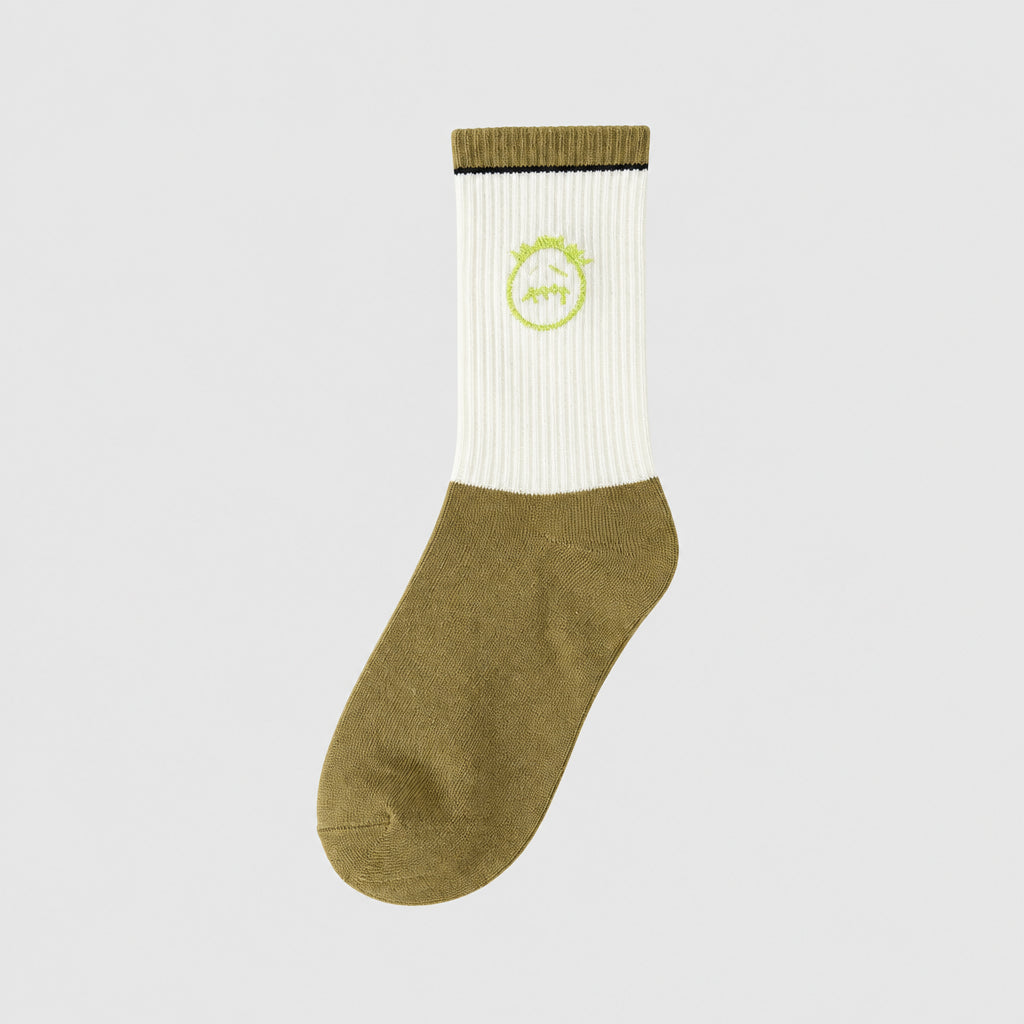 White and olive crew sock with a lime green stitched-face graphic and an olive cuff, angled view