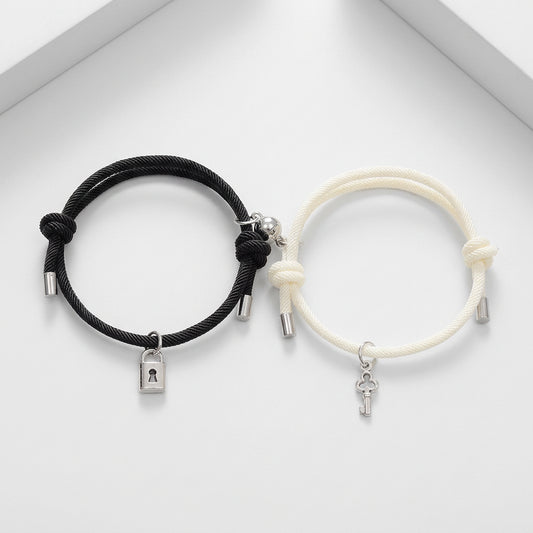 Black and white bracelets with charms on a white background