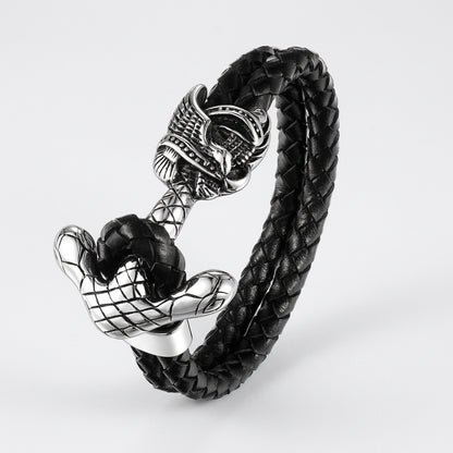 Black braided leather bracelet with silver skull and anchor design on a white background