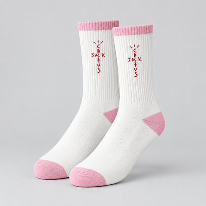 White crew socks with pink cuffs, heels and toes and red cross-shaped lettering.