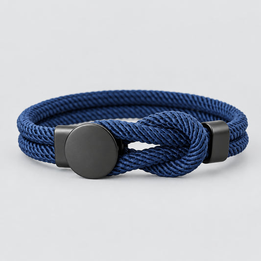 A red bracelet with a knot design and a black fastening mechanism, presented against a white background.