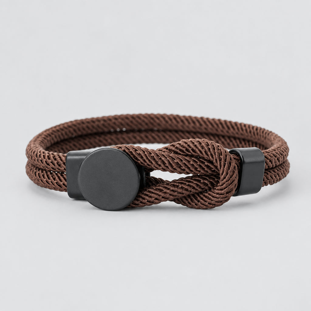 Brown braided bracelet with metal clasp on a white background