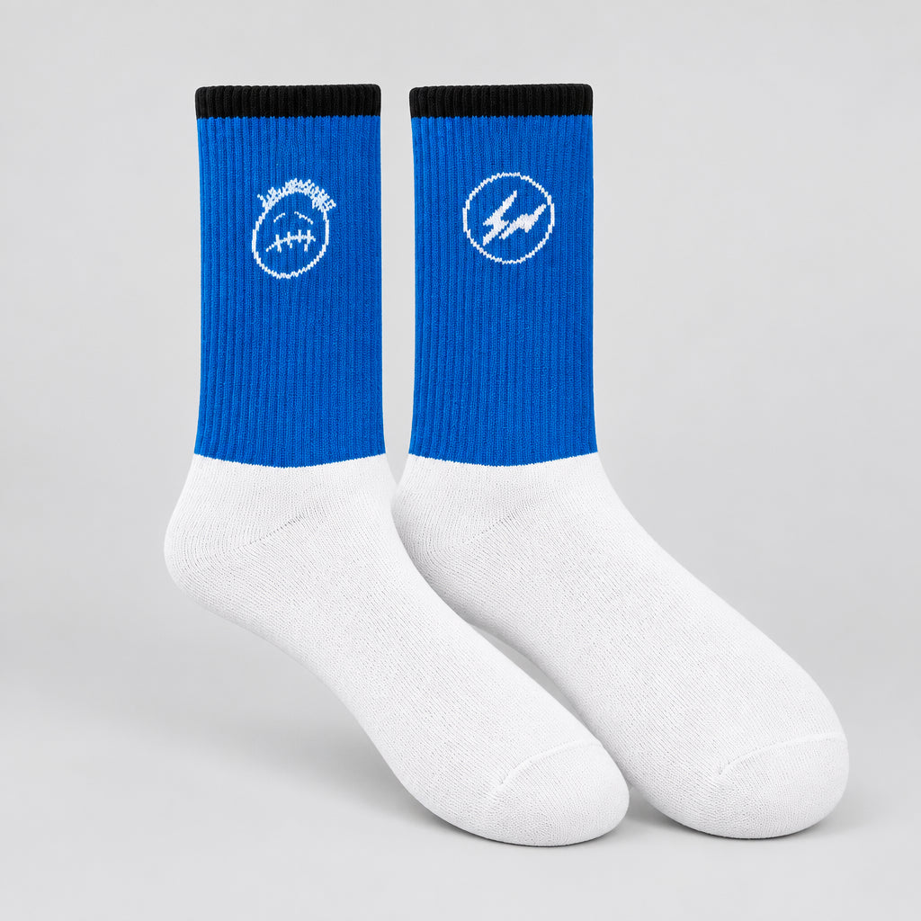 Blue and white crew socks with black cuffs, a white face graphic and a circular lightning design.