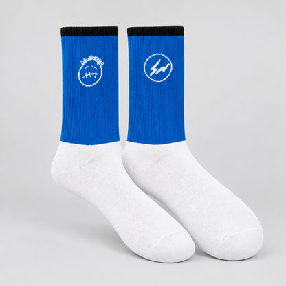 Blue and white crew socks with black cuffs, a white face graphic and a circular lightning design.