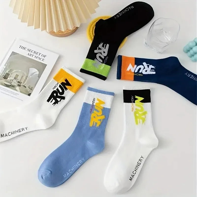 Colorful socks with branding on a white surface