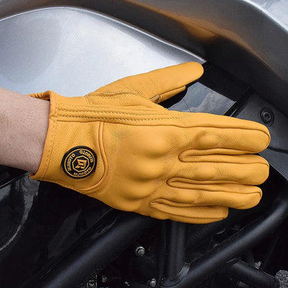 Yellow glove with a brand logo on a motorcycle engine