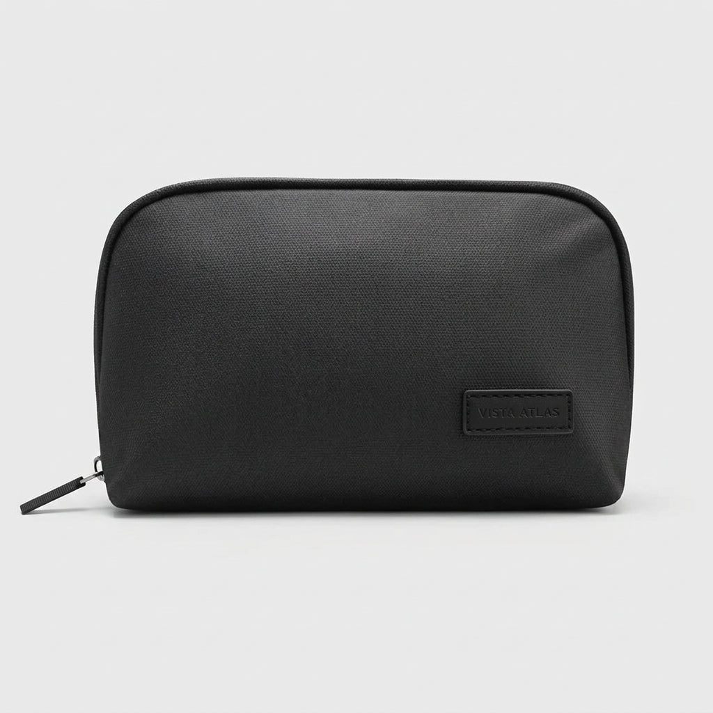Black organizer pouch shown closed with its zipper pull and stitched label patch.