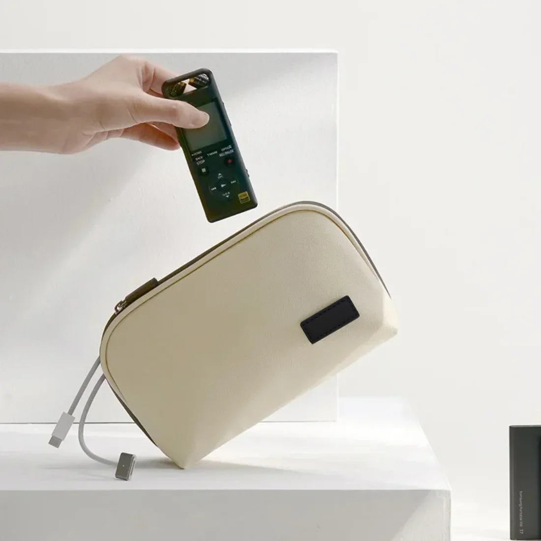 Beige organizer pouch shown with an example phone and small accessories.