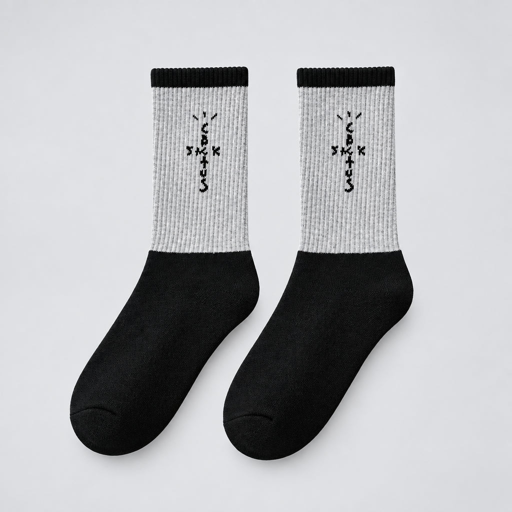 Gray and black crew socks with black cross-shaped lettering and black cuffs, angled view