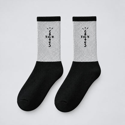 Gray and black crew socks with black cross-shaped lettering and black cuffs, angled view