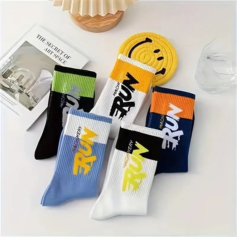Set of colorful socks with 'RUN' text on a white surface