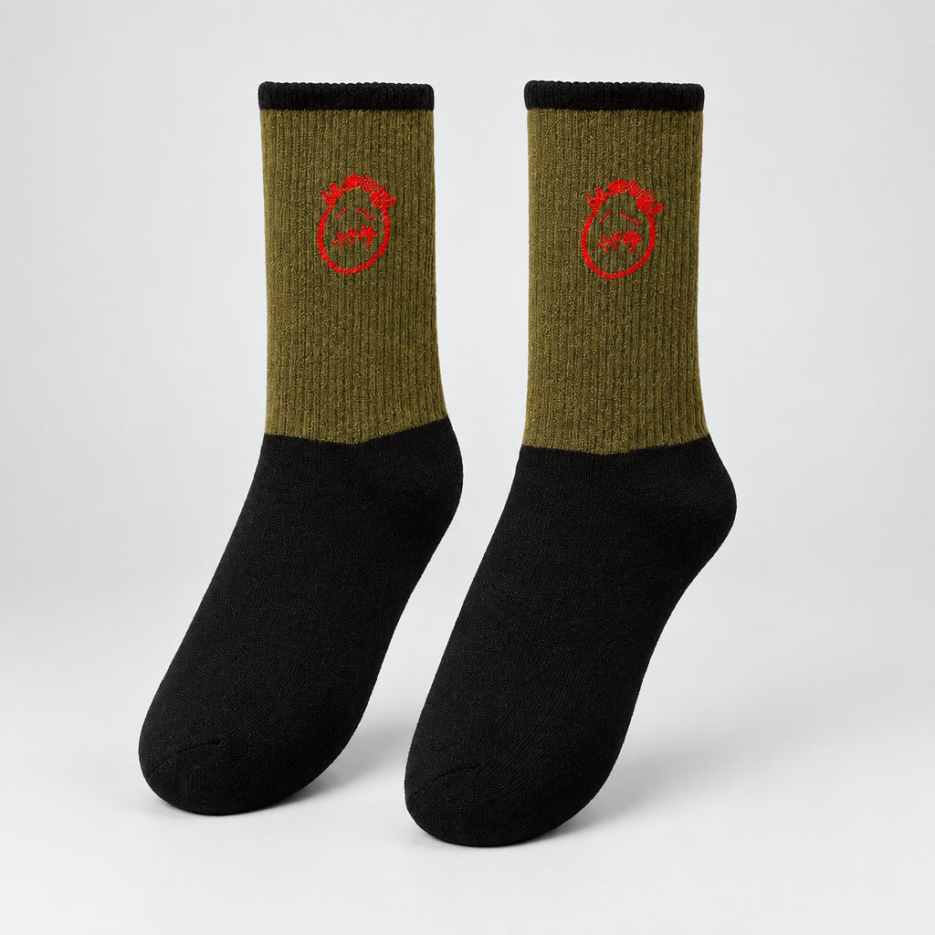 Olive and black crew socks with red stitched-face graphics and black cuffs, angled view