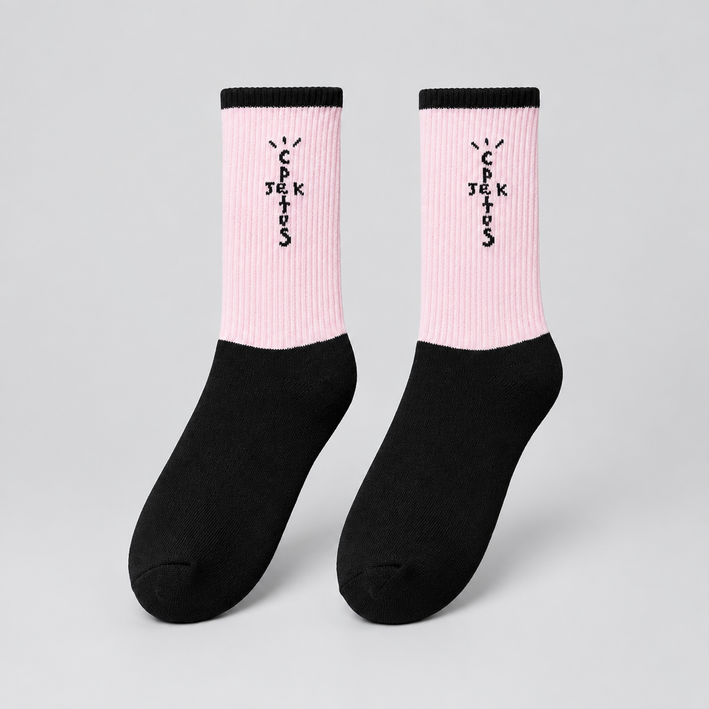 Pink and black crew socks with black cross-shaped lettering and black cuffs, angled view