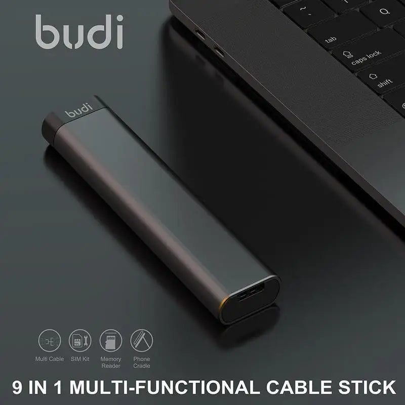 A black multi-functional USB-C hub with SD and TF card slots, and a phone holder feature, placed on a laptop.