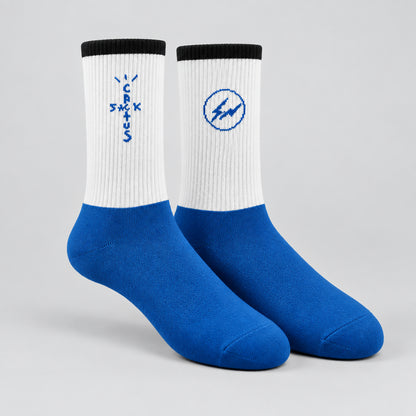 White and blue crew socks with black cuffs, blue cross-shaped lettering and a circular lightning design.