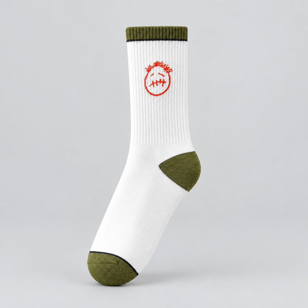 White crew sock with a red stitched-face graphic and olive cuff, heel, and toe, angled view