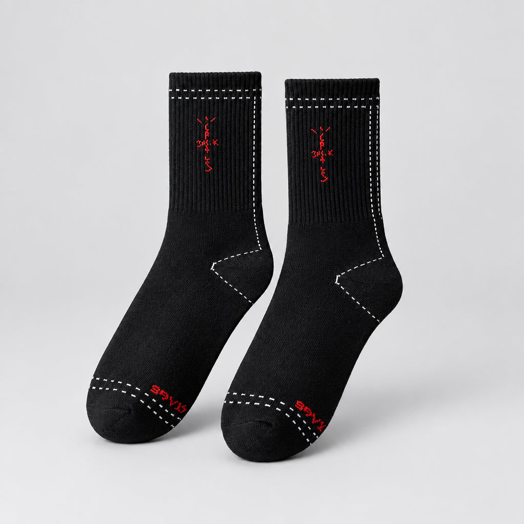 Black crew socks with red cross-shaped lettering and white dashed outlines, angled view