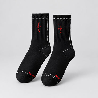 Black crew socks with red cross-shaped lettering and white dashed outlines, angled view