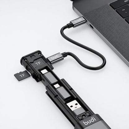 Multi-device charging cable with USB ports and TF card slot attached to a laptop.