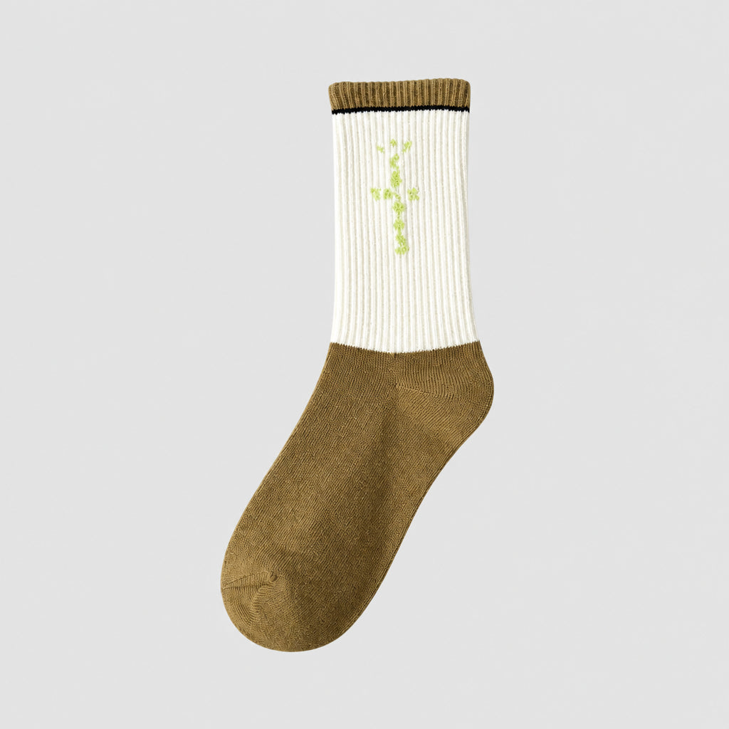 White and olive crew sock with lime green cross-shaped lettering and an olive cuff, angled view