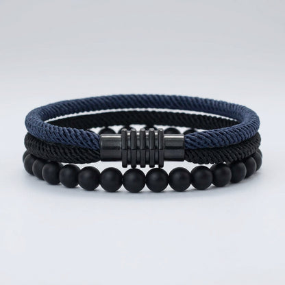 Two bracelets, one with a black braided rope design and the other with red, placed side by side with a silver-colored zinc alloy clasp.