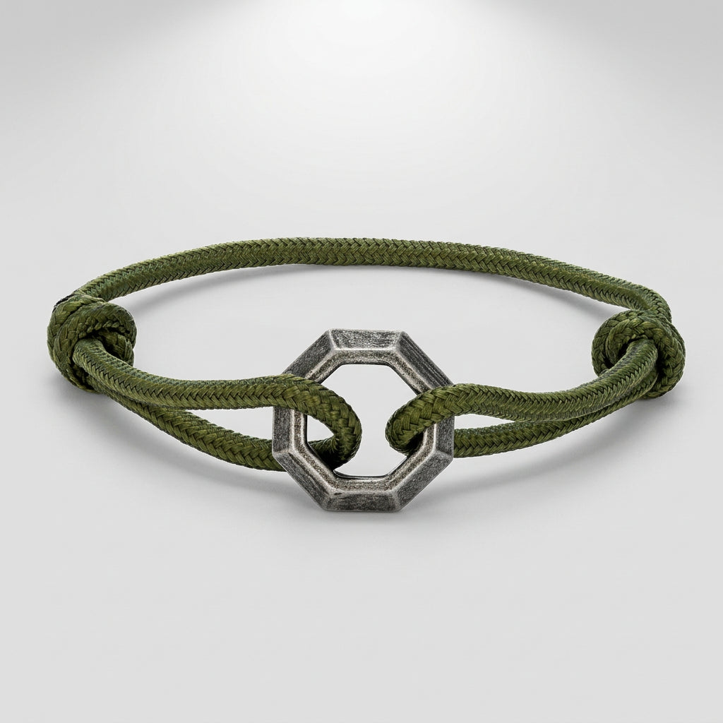 Green bracelet with a silver hexagonal clasp on a white background