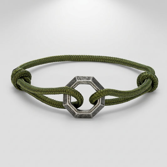Green bracelet with a silver hexagonal clasp on a white background